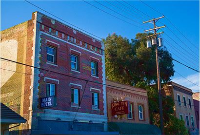 Brick buildings next to a utility pole with a clear blue sky in the background