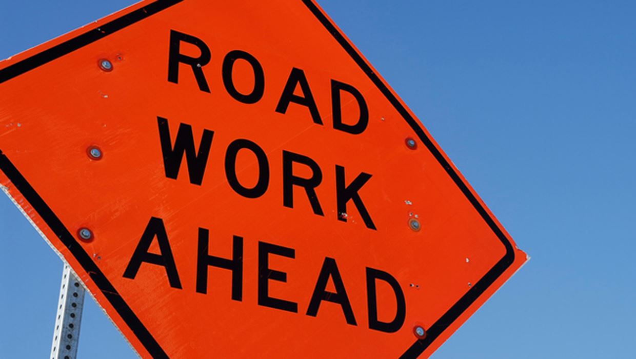 Orange construction sign indicating road work ahead